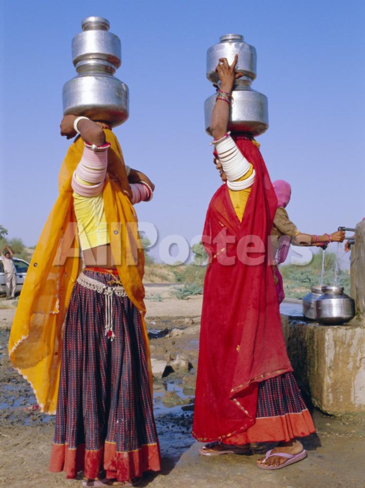 bruno-morandi-two-women-by-a-well-carrying-water-pots-barmer-rajasthan-india.jpg