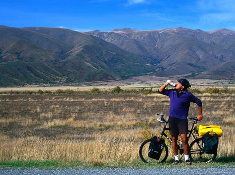 Cyclist Having a Drink on the Side of the Highway between Twizel and Omarama, Otago, New Zealand Photographic Print