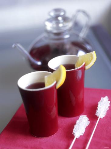 anita-oberhauser-two-beakers-of-fruit-tea-with-lemon-wedges-sugar-sticks.jpg