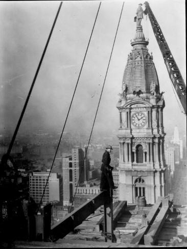 Worker at Skyscraper Building Site, with City Visible Below Him Photographic Print