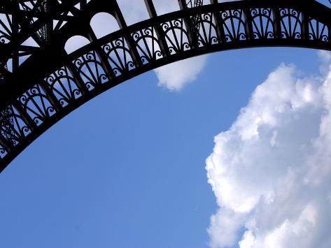 Detailed Picture  Eiffel Tower on Detailed Arch On The Eiffel Tower Against Blue Sky And Clouds