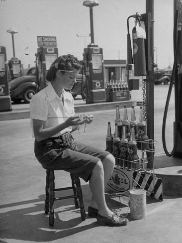allan-grant-girl-change-maker-knitting-during-slow-moments-at-the-gilmore-self-service-gas-station.jpg