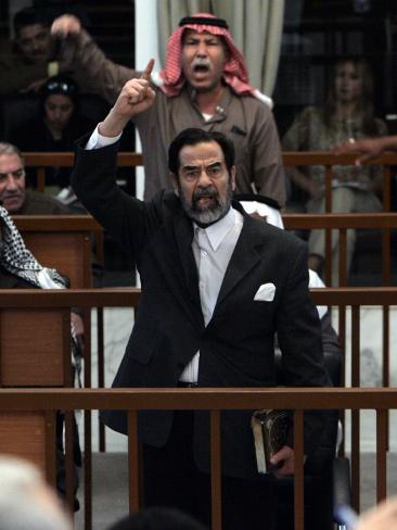 former-iraqi-president-saddam-hussein-berates-the-court-during-their-trial-in-baghdad.jpg