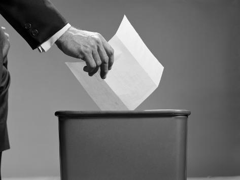 h-armstrong-roberts-man-s-hand-tossing-paper-into-trash-can.jpg
