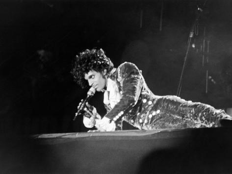 http://imgc.allpostersimages.com/images/P-473-488-90/65/6570/CC82100Z/posters/michael-cheers-prince-lying-on-stage-during-his-purple-rain-tour-1984.jpg