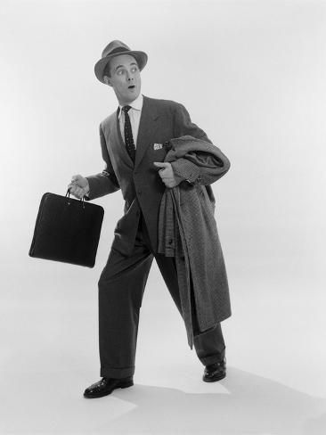 1950s-surprised-businessman-holding-briefcase-taking-a-step-forward-looking-back.jpg