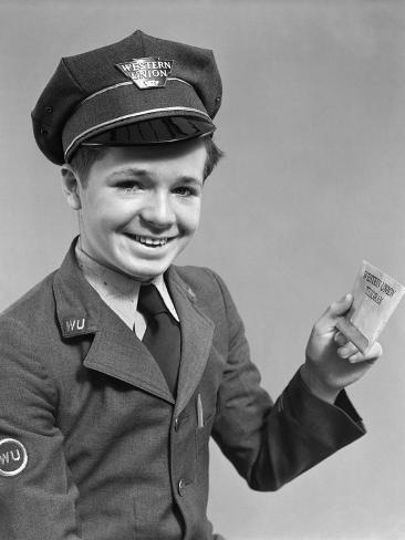 1920s-1940s-smiling-boy-wearing-a-western-union-uniform-and-hat-holding-a-telegram.jpg