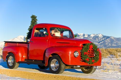 Santa Driving a Vintage Red Ford Pick-Up Truck Down a ...