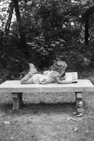 Girl Reading on Bench Photographic Print