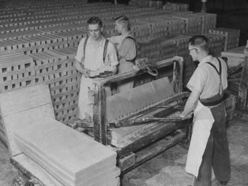 a view of workers cutting slabs of soap into bars from a story concerning port sunlight