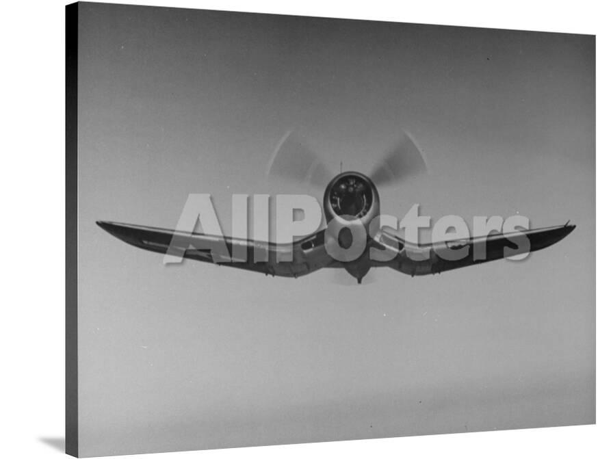 An F4u Fighter Plane Flying Through The Air Photographic Print At
