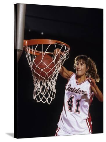 female basketball player dunking