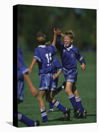 11 Year Old Boys Soccer Player Celebates a Goal-null-Stretched Canvas