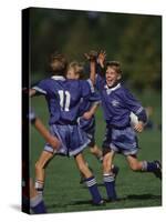 11 Year Old Boys Soccer Player Celebates a Goal-null-Stretched Canvas