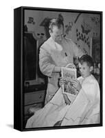 12 Year Old Boy Sitting in Barber Chair Having His Hair Cut and Reading Comics-Alfred Eisenstaedt-Framed Stretched Canvas