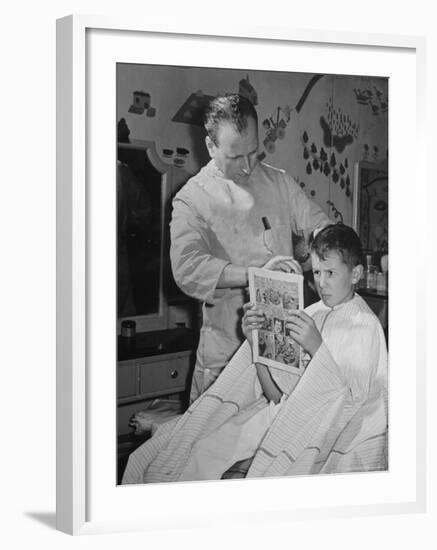 12 Year Old Boy Sitting in Barber Chair Having His Hair Cut and Reading Comics-Alfred Eisenstaedt-Framed Photographic Print