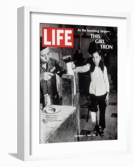 12-Year-Old Vietnamese Girl Nguyen Thi Tron Watching New Wooden Leg Being Made, November 8, 1968-Larry Burrows-Framed Photographic Print