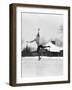 1920s 1930s MAN ICE SKATING ON OUTDOOR ICE RINK DOING AN ARABESQUE JUMPING-Panoramic Images-Framed Photographic Print