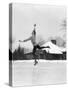 1920s 1930s MAN ICE SKATING ON OUTDOOR ICE RINK DOING AN ARABESQUE JUMPING-Panoramic Images-Stretched Canvas