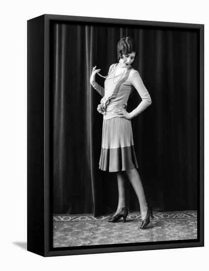 1920s FLAPPER WOMAN POSING HAND ON HIP HOLDING STRING OF PEARLS STRETCHING LEG CHECKING HOSIERY...-Panoramic Images-Framed Stretched Canvas