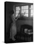 1920s WOMAN PARTY DRESS RUFFLES ON SKIRT PLACING A LIGHTED CANDLE IN WINDOW GIFTS PRESENTS WRAPP...-Panoramic Images-Stretched Canvas