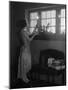 1920s WOMAN PARTY DRESS RUFFLES ON SKIRT PLACING A LIGHTED CANDLE IN WINDOW GIFTS PRESENTS WRAPP...-Panoramic Images-Mounted Photographic Print