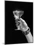 1930s 1940s 1950s WOMAN HAND ORNATE METAL BRACELET HOLDING UP NEW YEAR TOAST GLASS OF CHAMPAGNE...-Panoramic Images-Mounted Photographic Print