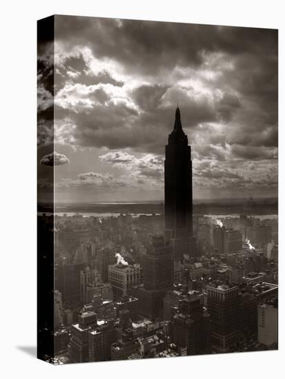 1930s-1940s Empire State Building Silhouetted Against High Gathering Storm Clouds Covering NYC-null-Stretched Canvas