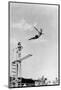 1930s 1940s SHAPELY WOMAN WATCHING MAN SWAN DIVE OFF HIGH DIVING BOARD-H. Armstrong Roberts-Mounted Photographic Print