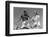 1930s 1940s SMILING BLONDE COUPLE ON BIKES LOOKING AT ONE ANOTHER-H. Armstrong Roberts-Framed Photographic Print