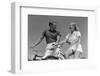 1930s 1940s SMILING BLONDE COUPLE ON BIKES LOOKING AT ONE ANOTHER-H. Armstrong Roberts-Framed Photographic Print