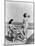 1930s 1940s TWO WOMEN SITTING ON HOTEL DECK BEACH SIDE IN ONE PIECE BATHING SUIT FASHION FLORIDA...-Panoramic Images-Mounted Photographic Print