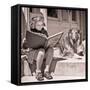 1930s ENGROSSED LITTLE GIRL OUTDOOR READING BIG BOOK SITTING NEXT TO ROUGH COLLIE DOG LOOKING AT...-H. Armstrong Roberts-Framed Stretched Canvas