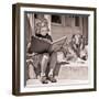 1930s ENGROSSED LITTLE GIRL OUTDOOR READING BIG BOOK SITTING NEXT TO ROUGH COLLIE DOG LOOKING AT...-H. Armstrong Roberts-Framed Photographic Print