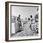 1930s MAN WOMAN WEARING BATHING SUITS ON TERRACE OVERLOOKING SWIMMING POOL WOMAN ON DIVING BOARD-Panoramic Images-Framed Photographic Print