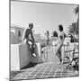 1930s MAN WOMAN WEARING BATHING SUITS ON TERRACE OVERLOOKING SWIMMING POOL WOMAN ON DIVING BOARD-Panoramic Images-Mounted Photographic Print