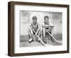 1930s TWO SMILING BOYS STREET HOCKEY PLAYERS SITTING ON CURB WEARING METAL ROLLER SKATES HOLDING...-Panoramic Images-Framed Photographic Print