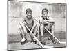 1930s TWO SMILING BOYS STREET HOCKEY PLAYERS SITTING ON CURB WEARING METAL ROLLER SKATES HOLDING...-Panoramic Images-Mounted Photographic Print