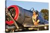 1940's Style Aviator Pin-Up Girl Posing with a Vintage T-6 Texan Aircraft-null-Stretched Canvas