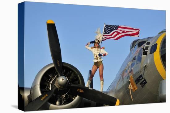 1940's Style Majorette Pin-Up Girl on a B-17 Bomber with an American Flag-null-Stretched Canvas