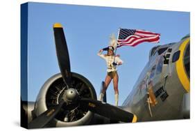 1940's Style Majorette Pin-Up Girl on a B-17 Bomber with an American Flag-null-Stretched Canvas