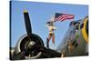1940's Style Majorette Pin-Up Girl on a B-17 Bomber with an American Flag-null-Stretched Canvas