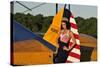 1940's Style Pin-Up Girl Leaning on the Tail Fin of a Stearman Biplane-null-Stretched Canvas