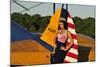 1940's Style Pin-Up Girl Leaning on the Tail Fin of a Stearman Biplane-null-Mounted Photographic Print