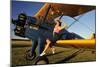 1940's Style Pin-Up Girl Sitting on the Wing of a Stearman Biplane-null-Mounted Premium Photographic Print