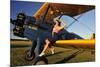 1940's Style Pin-Up Girl Sitting on the Wing of a Stearman Biplane-null-Mounted Photographic Print