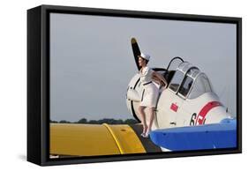 1940's Style Pin-Up Girl Sitting on the Wing of a Vintage T-6 Texan Aircraft-null-Framed Stretched Canvas