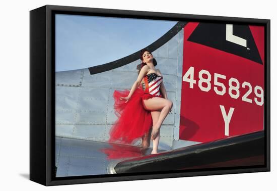 1940's Style Pin-Up Girl Standing on the Tail of a B-17 Bomber-null-Framed Stretched Canvas