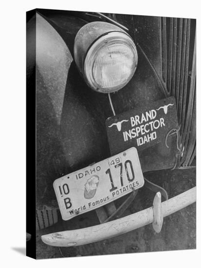 1949 Idaho License Plate Featuring a Buttered Baked Potato on a Cattle Brand Inspector's Car-null-Stretched Canvas