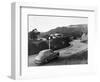1950s AUSTIN CAR DRIVING UP THE HOLLYWOOD HILLS WITH HOLLYWOOD SIGN IN DISTANCE LOS ANGELES CA USA-Panoramic Images-Framed Photographic Print